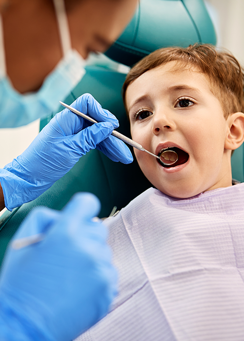 A dentist working with a child patient.