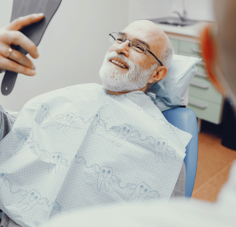 Older man proud of his new dentures