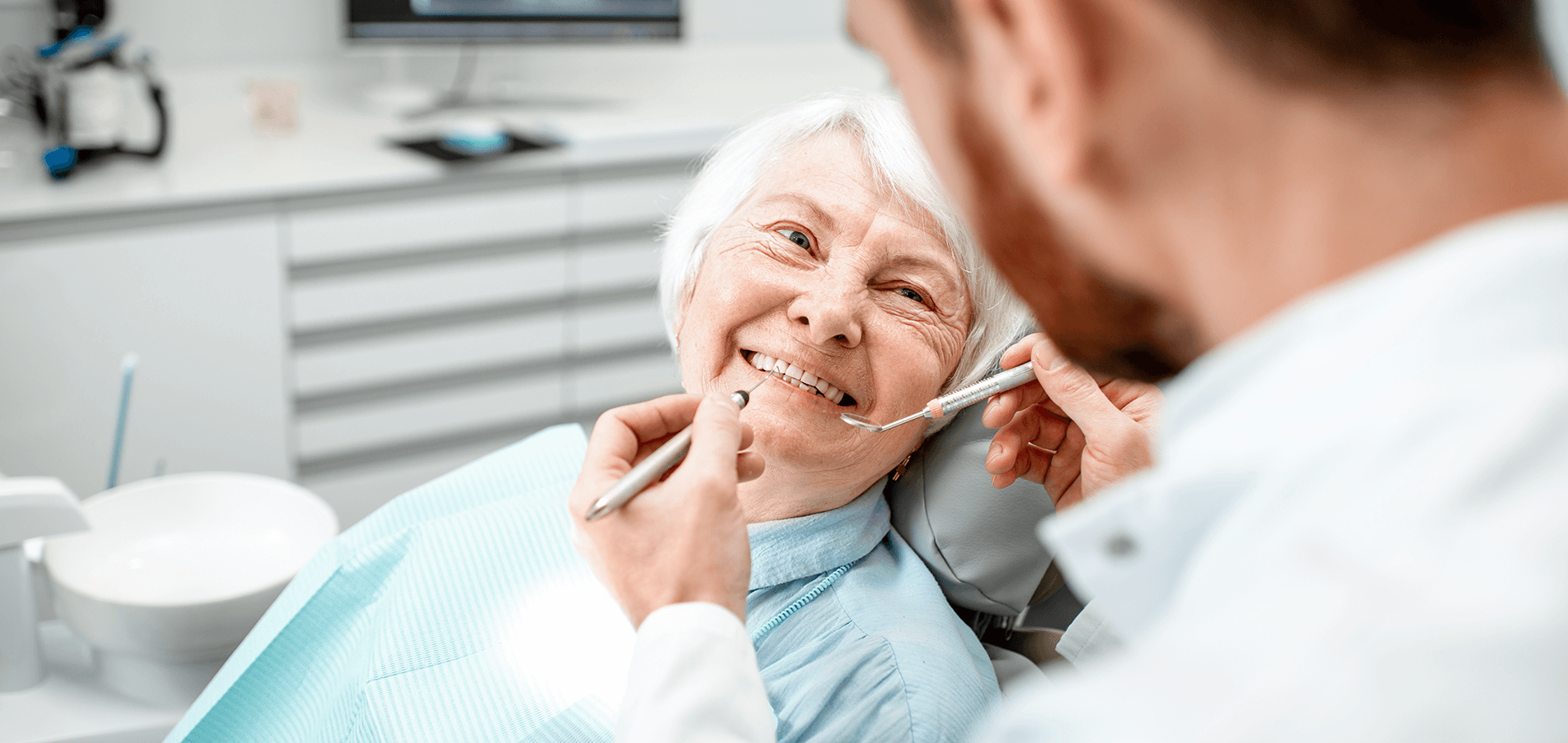 A patient smiling at her dentist