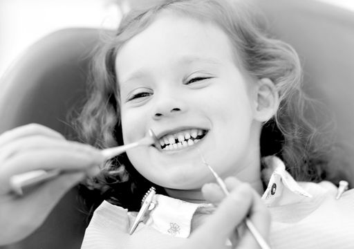 A dentist treating a child during a dental appointment.