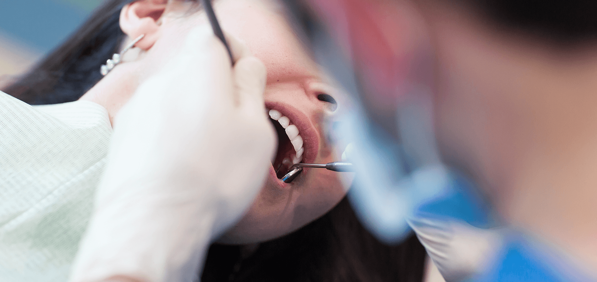 Dentist cleaning patient's teeth