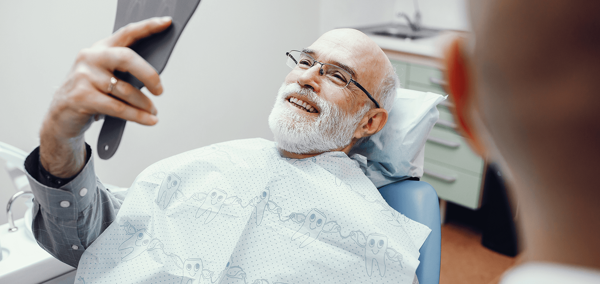 Patient checking out his new dental implants