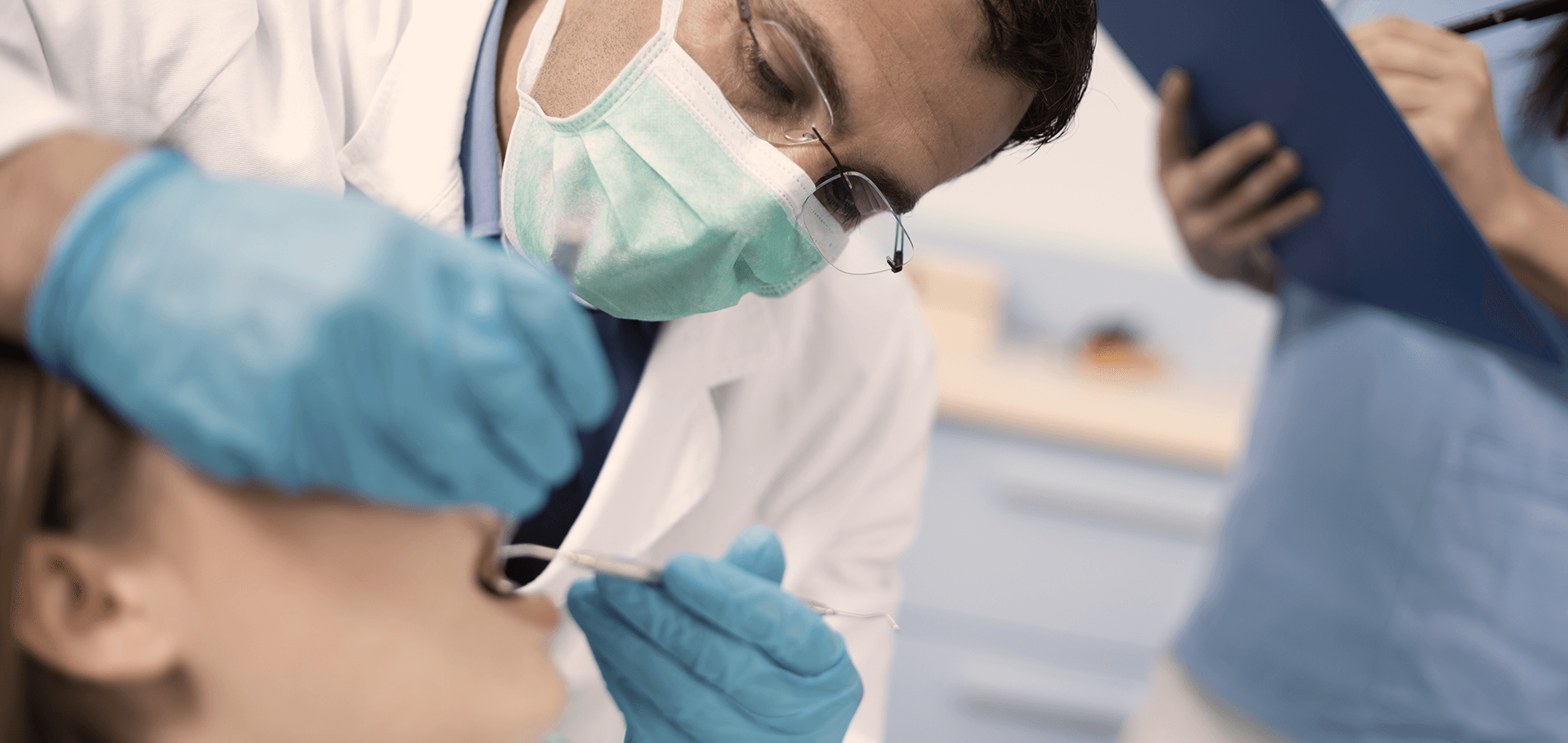 Dentist performing tooth extraction