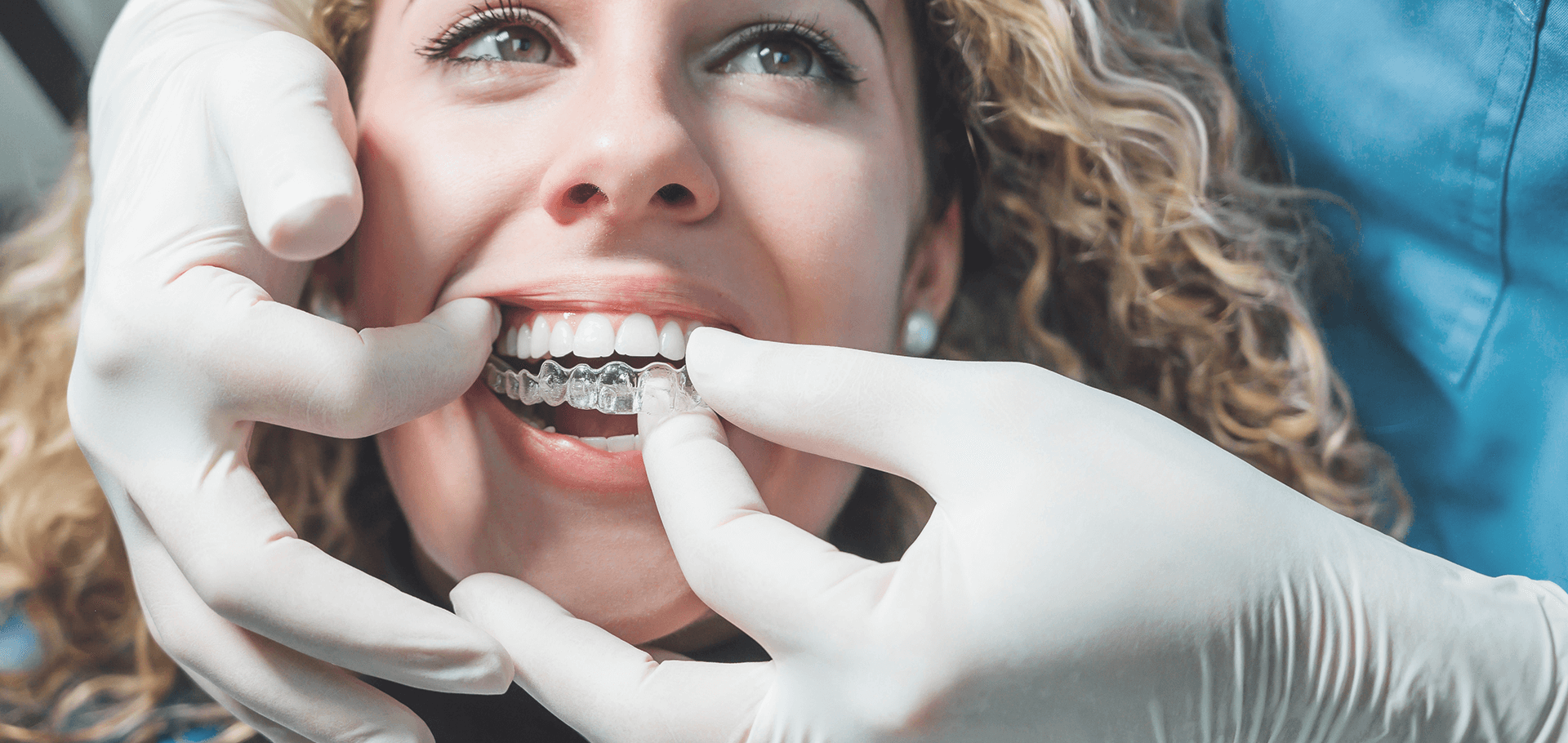 Patient trying on her visalign appliance